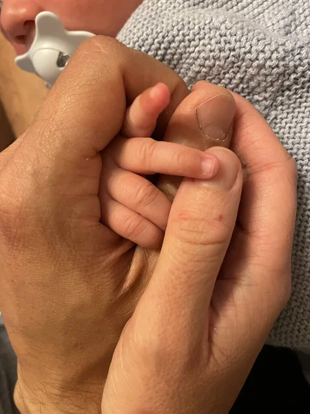 Closeup Adult Person Holding Newborn Child Hand Lights — Stock Photo, Image