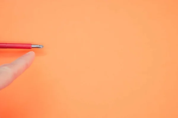 Renkli Bir Arkaplanda Tornavidayı Işaret Eden Bir Parmağın Yakın Plan — Stok fotoğraf