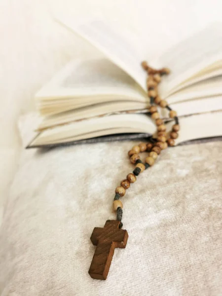 Вертикальный Снимок Деревянного Крестового Ожерелья Книгами Заднем Плане — стоковое фото
