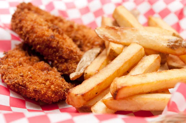 a big diner style plate of breaded chicken tenders and hand cut french fries