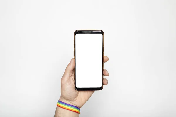 Hand Gay Pride Bracelet Holding Smartphone Blank Screen Isolated White — Stock Photo, Image