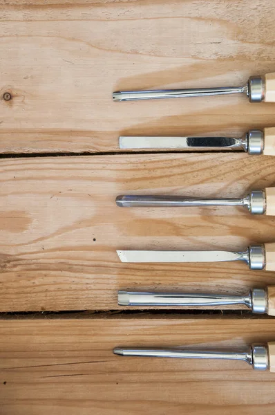 Vertical Shot Gouges Wooden Handles Table — Stock Photo, Image