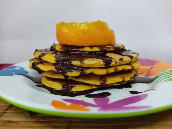 Closeup Shot Orange Pancakes Chocolate Colorful Plate Kitchen — Stock Photo, Image