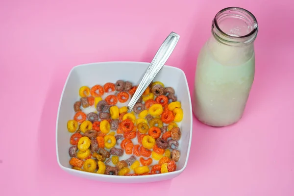 Bir Kase Renkli Çocuk Gevreği Pembe Bir Masada Süt — Stok fotoğraf