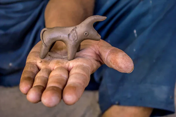 Closeup Shot Hand Holding Clay Figurine — Stockfoto
