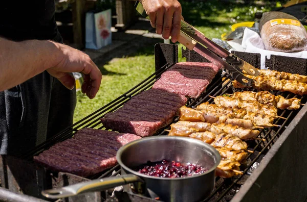 Person Holding Utensil Preparing Meat Grill Back Yard Sunny Day — ストック写真