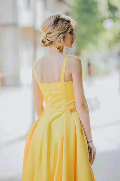 Vista Posterior Vertical Una Joven Rubia Posando Vestido Noche Amarillo —  Fotos de Stock