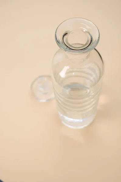 Vertical Shot Clear Glass Bottle Isolated Pink Surface Space Text — 스톡 사진