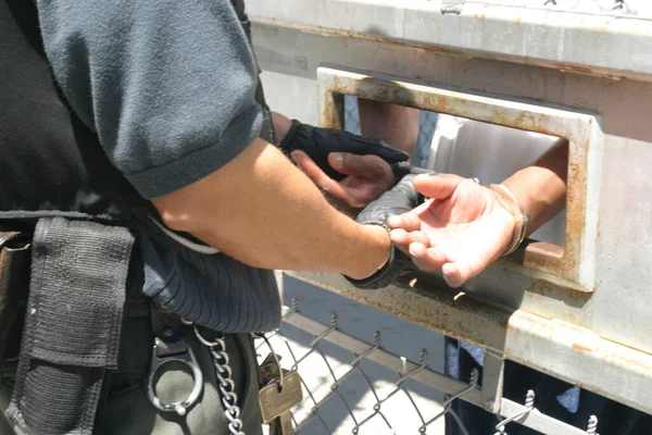 在加利福尼亚州斯托克顿市的青少年监狱 一名警官给一名囚犯戴手铐的特写镜头 — 图库照片