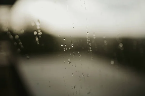 Selective Focus Shot Raindrops Window Blurred Dimly Lit Background — Stock Photo, Image