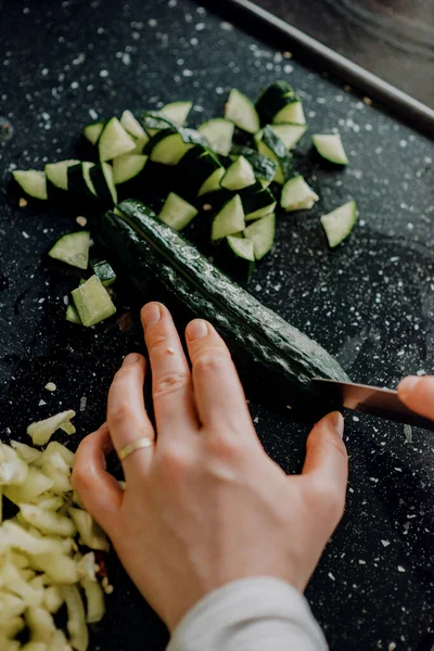 Een Verticaal Schot Van Handen Snijden Komkommer Het Zwarte Oppervlak — Stockfoto