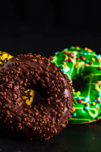 Eine Nahaufnahme Von Bunten Donuts Isoliert Auf Schwarzem Hintergrund — Stockfoto