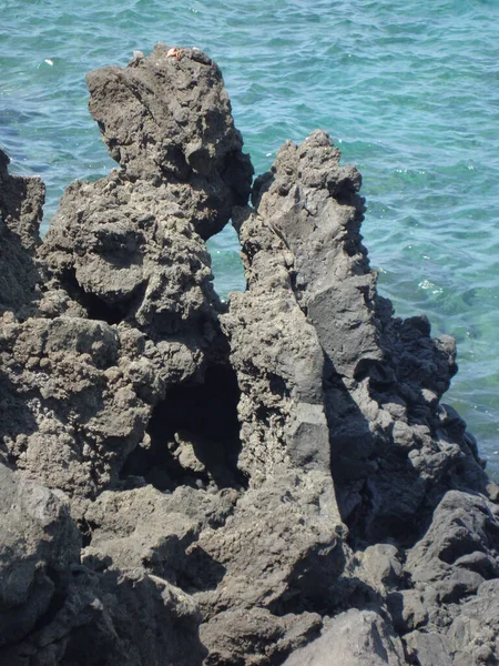 Black volcanic rocks at Waiulua Bay near Waikoloa, on Kona, the Big Island of Hawaii