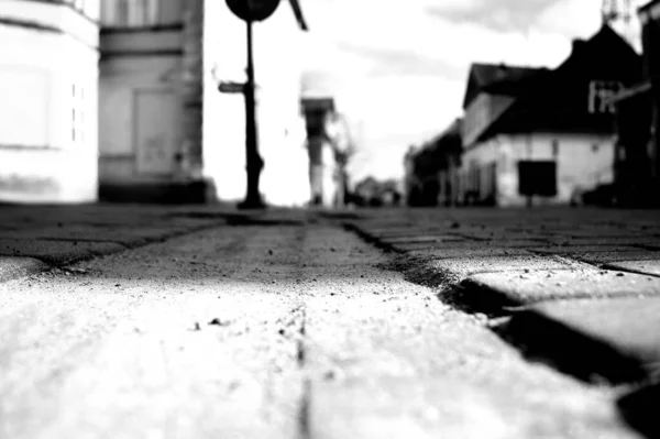 Grayscale Shot Old Brick Road Town Light Shining Buildings Back — Φωτογραφία Αρχείου