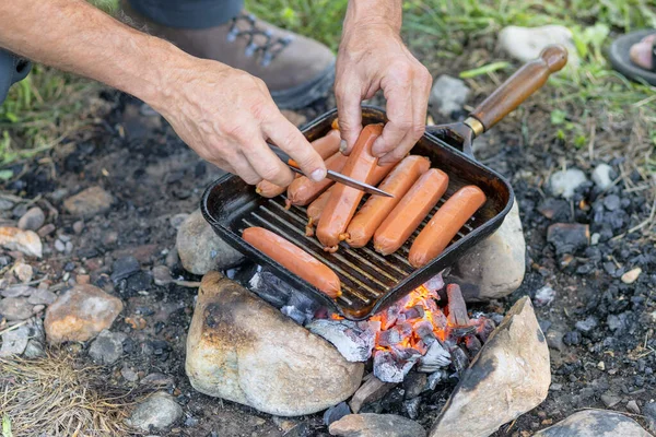 Uma Pessoa Cozinhar Salsichas Numa Fogueira Num Acampamento — Fotografia de Stock