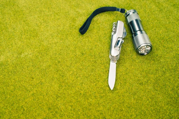 Top View Shot Steel Knife Flashlight Green Grass Surface — Stock Photo, Image