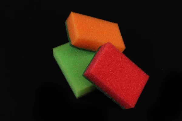 Closeup Three Colorful Sponges Black Background — Φωτογραφία Αρχείου