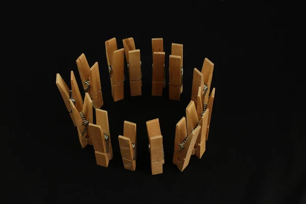 Closeup Wooden Clips Arranged Circle Black Background — Φωτογραφία Αρχείου