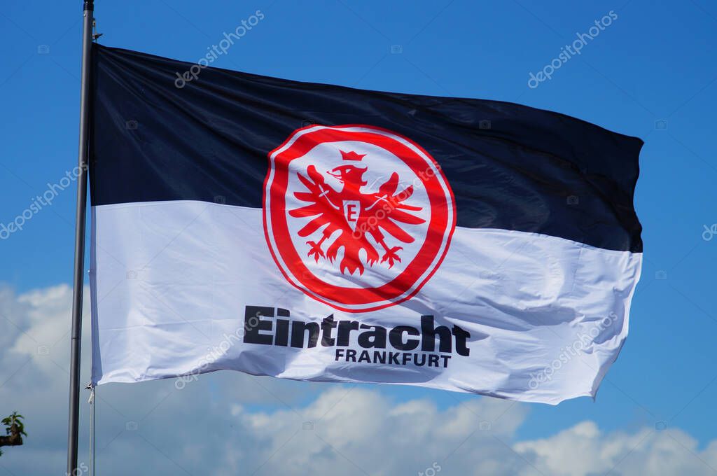 FRANKFURT, GERMANY - May 21, 2021: A flag of the national team Eintracht Frankfurt flies in an allotment garden. Fan culture is omnipresent in the city, espacially the 'Adler' (eagle).
