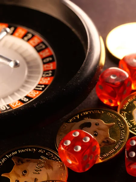 A vertical shot of golden poker chips and dice in the luxury roulette table background