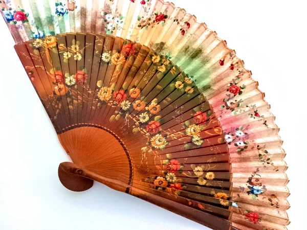 antique Spanish silk folding fan hand painted with artistic colorful floral designs. Ladies used it for cooling by waving it to create an airflow.