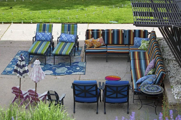 A shot of the colorful sofas and armchairs for the summer house that is being used outside.