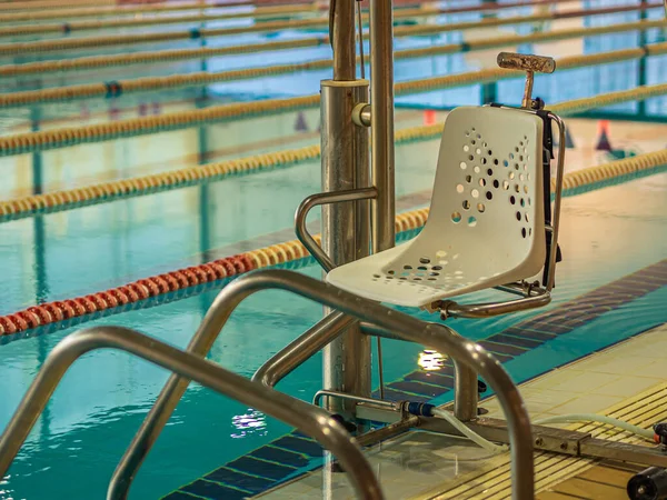 在模糊的游泳池背景上 一张体育中心塑料椅子的特写照片 — 图库照片