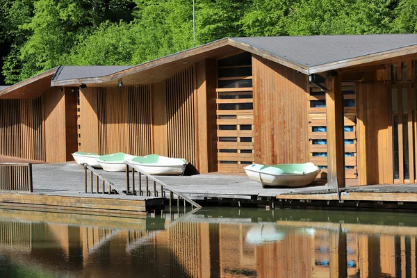 A beautiful view of pontoon boats docked on a wooden hut under sunlight