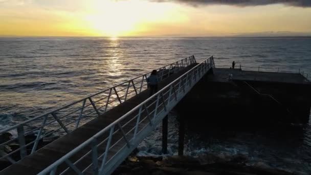 Aerial Footage Woman Walking Stone Pier Tranquil Sea Beautiful Sunset — Αρχείο Βίντεο