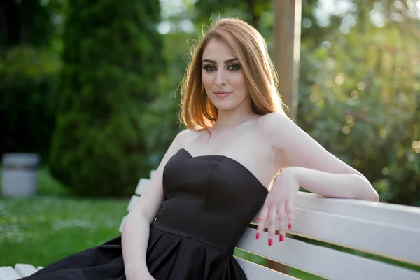 Young Attractive Woman Black Dress Sitting Bench Posing Green Park — стоковое фото