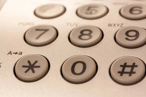 数字と記号の白い電話のボタンのクローズアップショット — ストック写真