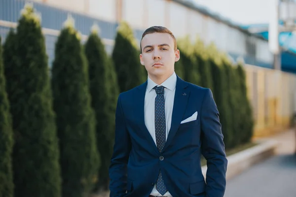 Confident Caucasian Young Man Blue Suit Posing Next Spruce Trees — ストック写真