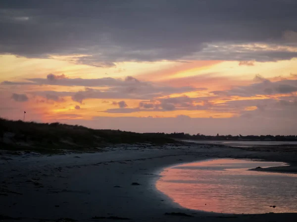 Ein Schöner Sandstrand Und Orangefarbener Sonnenuntergang Wolkenverhangener Himmel Der Sich — Stockfoto