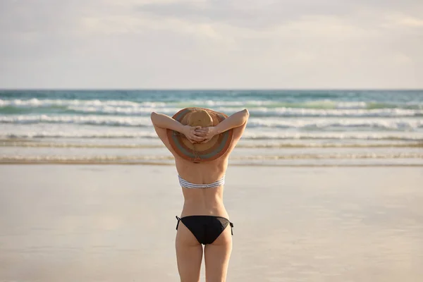 Bikini Hasır Şapkalı Bir Kız Sahilde Yürüyor — Stok fotoğraf