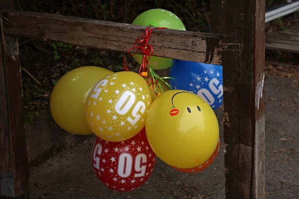 Group Bright Colorful 50Th Anniversary Balloons Tied Wooden Beam — Zdjęcie stockowe