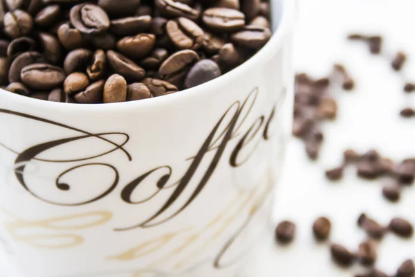 Closeup Mug Filled Roasted Coffee Beans White Surface — Foto de Stock