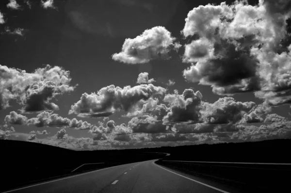 Grayscale Shot Beautiful Cloudscape Empty Road Forest Field — Stock Photo, Image
