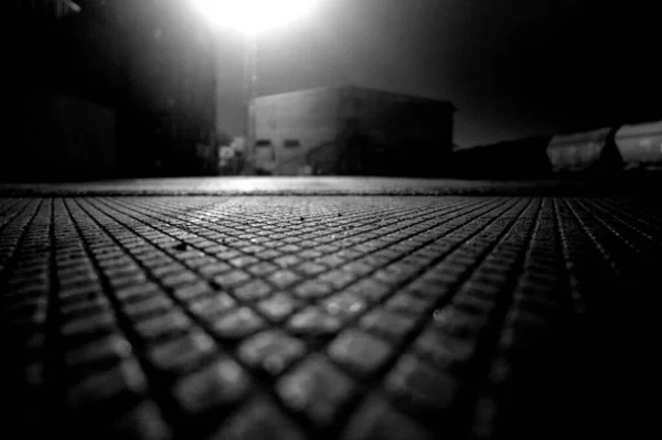 Ground Level Shot Textured Concrete Pavement Lit Streetlight Night — Φωτογραφία Αρχείου