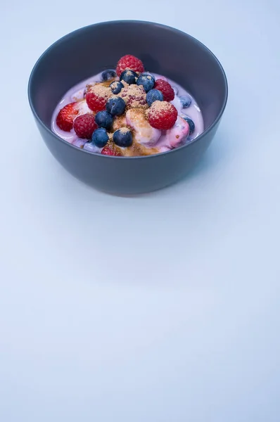 Bowl Yogurt Raspberries Blueberries Powder Isolated Light Blue Background — Stock Photo, Image
