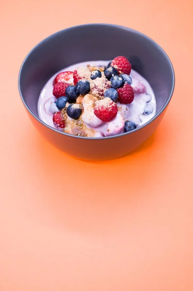 Bowl Yogurt Raspberries Blueberries Powder Isolated Orangbackground — Stock Photo, Image