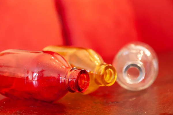 Closeup Shot Three Colorful Glass Bottles Red Background — Stock Photo, Image