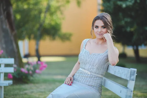 Una Attraente Donna Caucasica Indossa Elegante Abito Lungo Argento Seduta — Foto Stock