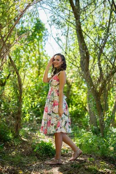 Приваблива Кавказька Жінка Одягнена Квіткове Вбрання Поставлене Парку Повному Дерев — стокове фото