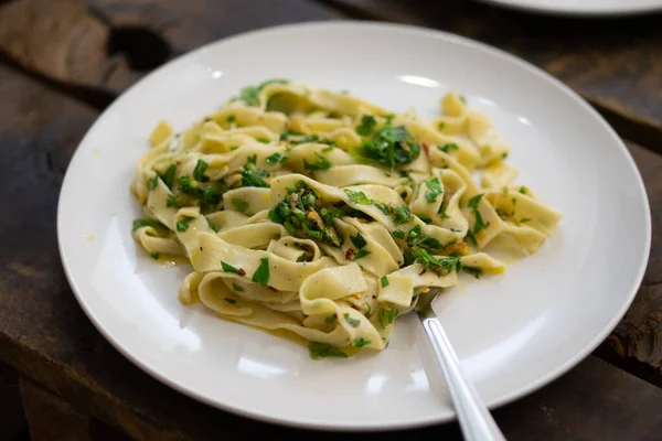 Closeup Delicious Fettuccine Pasta Herbs White Plate Wooden Surface — Stockfoto