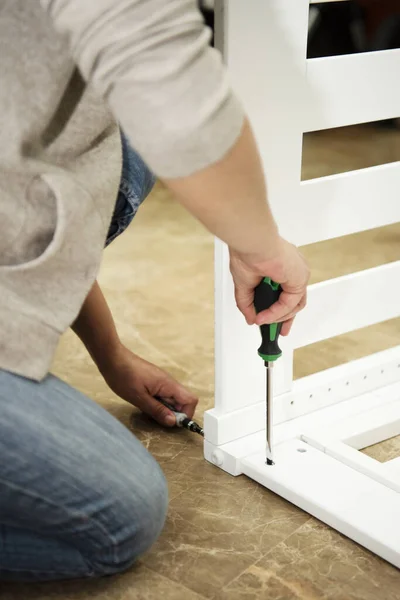 Hispanic Female Uses Tools Assemble Baby Crib — Stockfoto