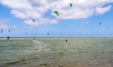 LABOE, GERMANY - Jun 13, 2021: Lots of kite surfing activity at the Baltic Sea beach of Laboe in Germany clipart