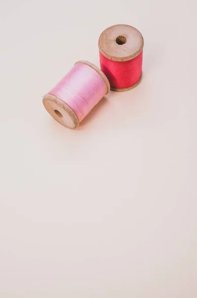 Spool of Pink Thread and Thimble on Vintage Pink Satin and Feather Fabric  Stock Photo - Alamy