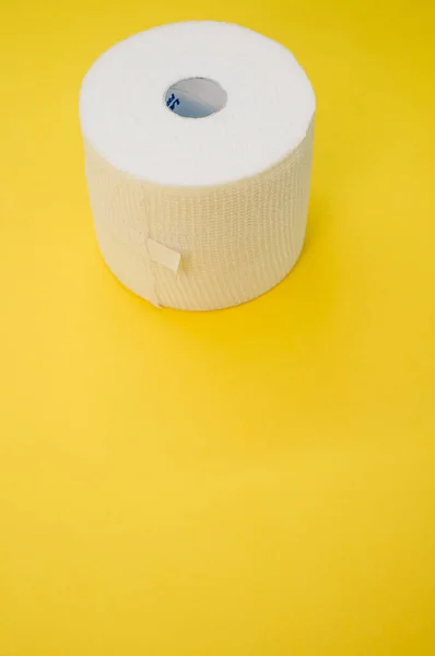 Vertical Shot Sterile Gauze Bandage Roll Isolated Yellow Background — Stock Photo, Image