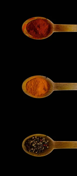 Vertical Shot Wooden Spoons Pepper Paprika Cayenne Spices Black Background — Stock Photo, Image