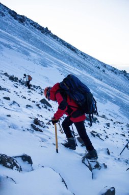 A hiker with a backpack climbing the Pico de Orizaba clipart